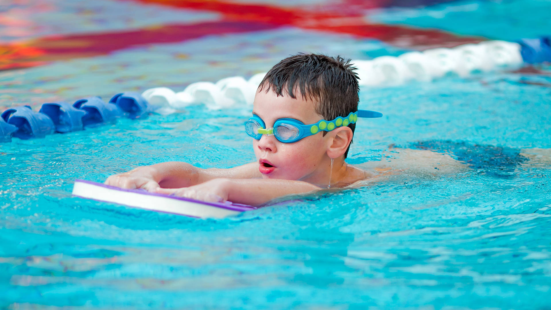 A child learning to swim during a swimming lesson in Castle Royle's swimming pool